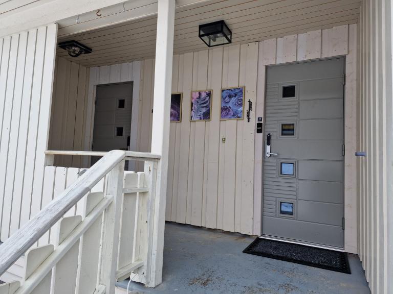 Ytterdøren til eneboligen er til høyre. Døren til venstre tilhører en utleid kjellerleilighet.